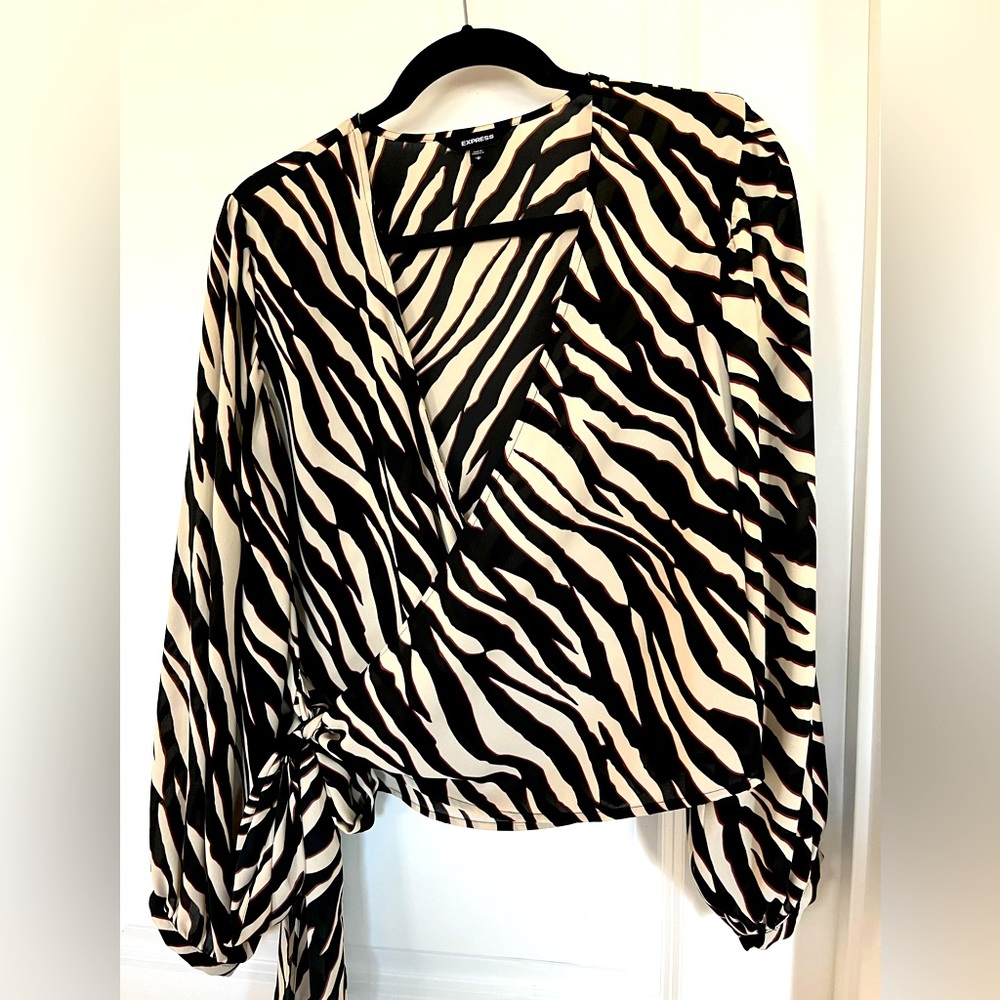 Express wrap around blouse in zebra print. Size M